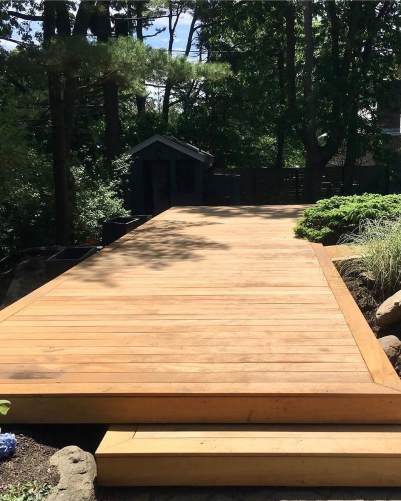 Garapa wood deck in shaded San Francisco backyard surrounded by trees and natural landscaping